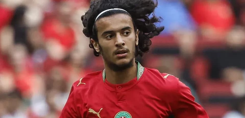 Player running in red Morocco jersey during match