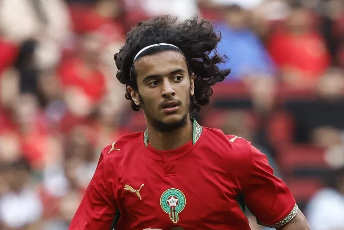 Player running in red Morocco jersey during match