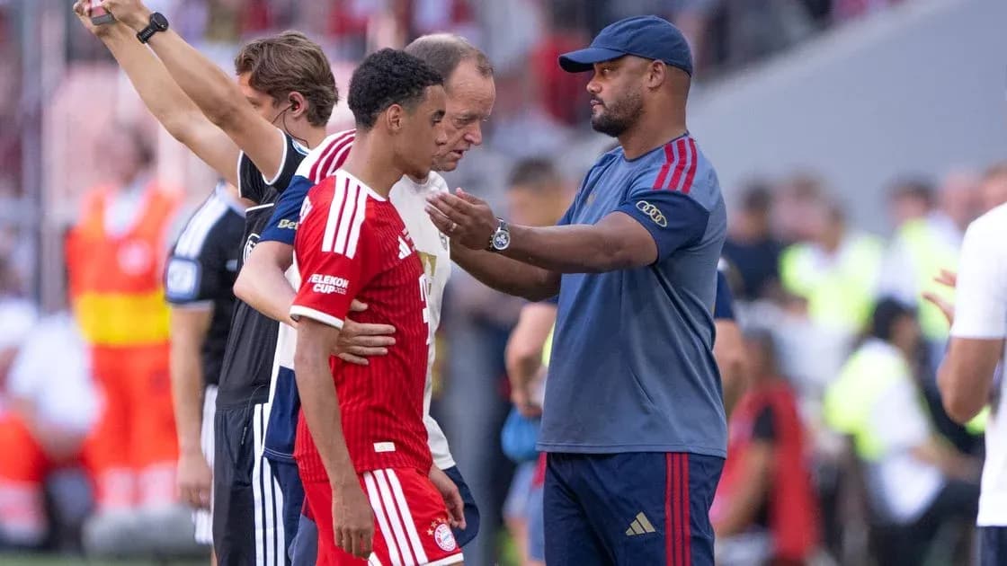 Coach interacting with player during match substitution