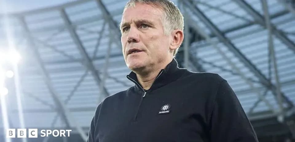 Coach speaking during a press conference at stadium