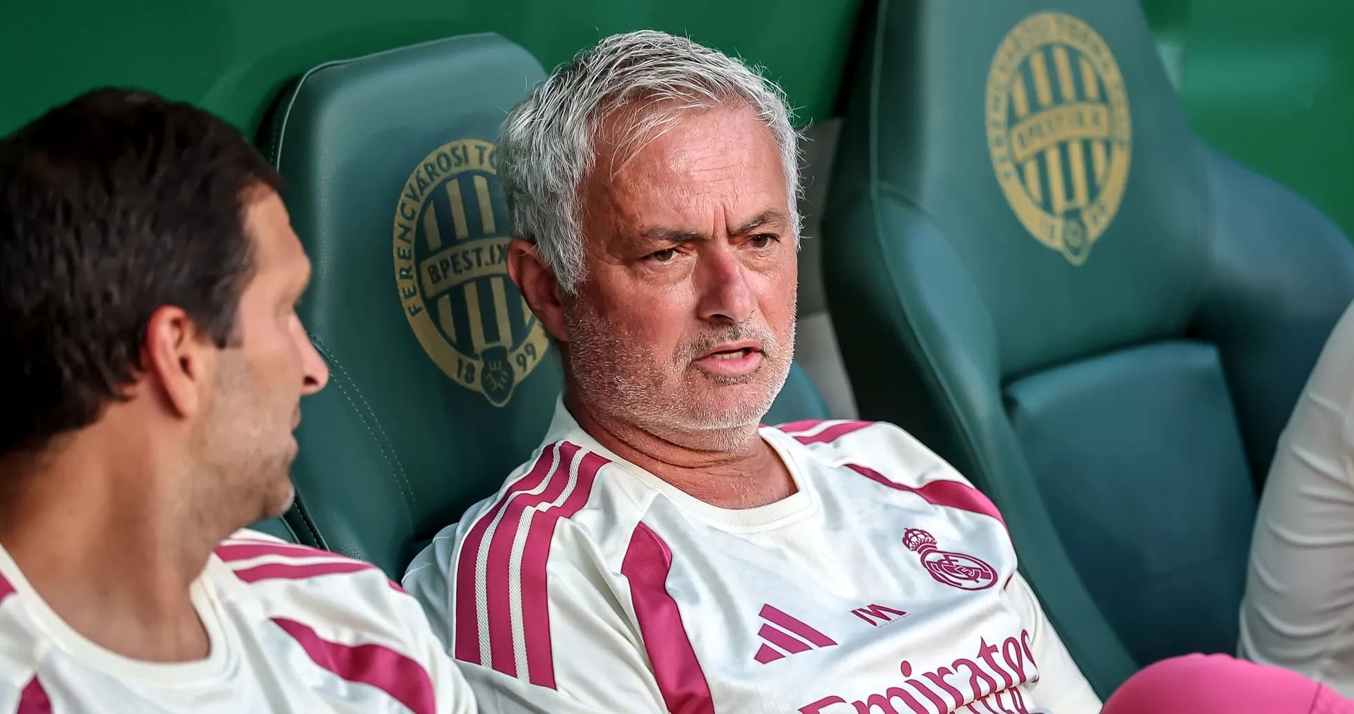 Coach discussing strategy on the bench during match