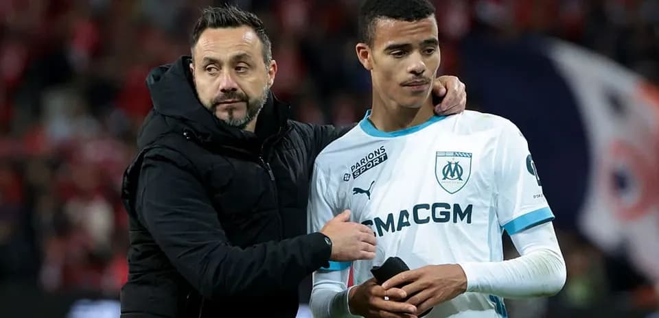 Coach comforting player after match on field