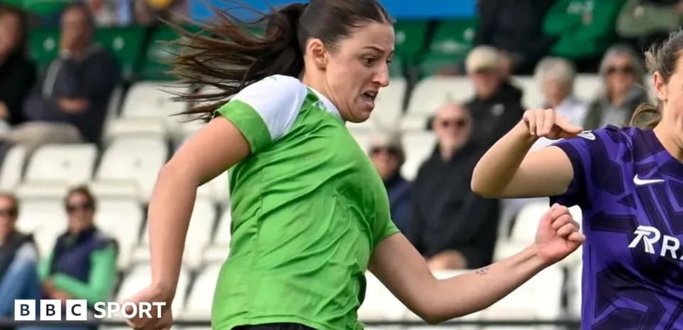Player in green jersey kicking ball during match