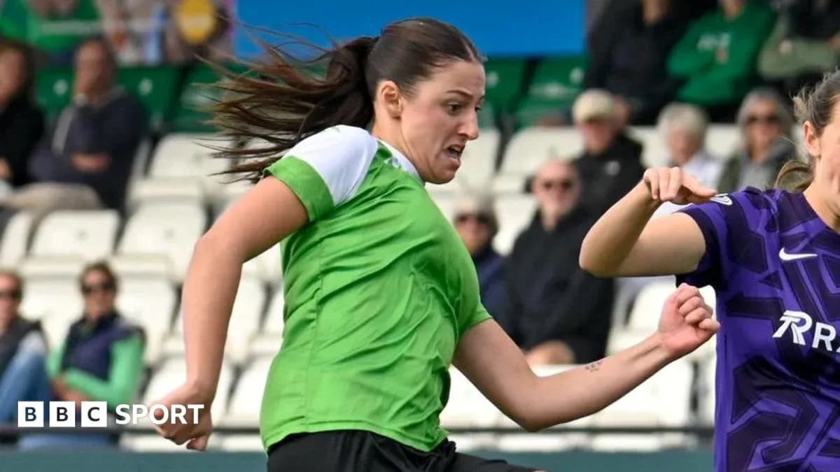 Player in green jersey kicking ball during match
