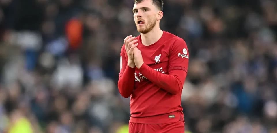 Player in red Liverpool kit applauding fans