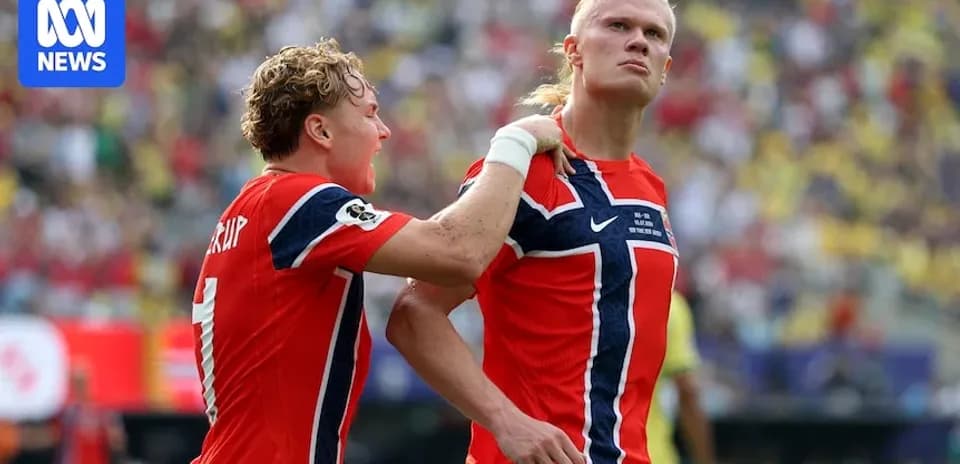 Two Norwegian players celebrating a goal during match