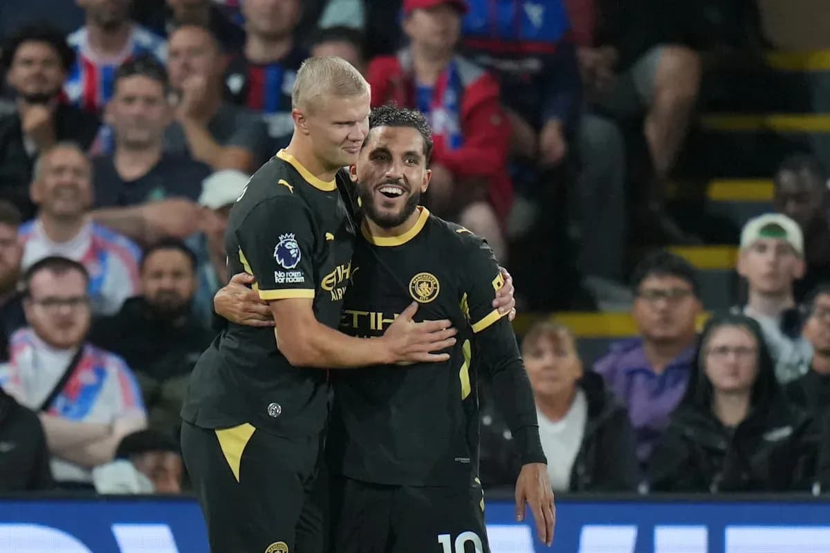 Two Manchester City players celebrating a goal