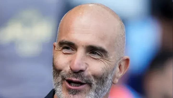 Smiling man with a bald head and beard