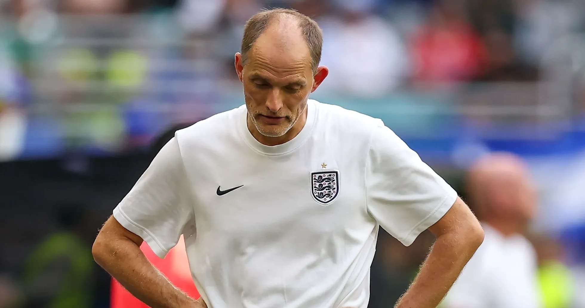 Coach looking down during a match on the field