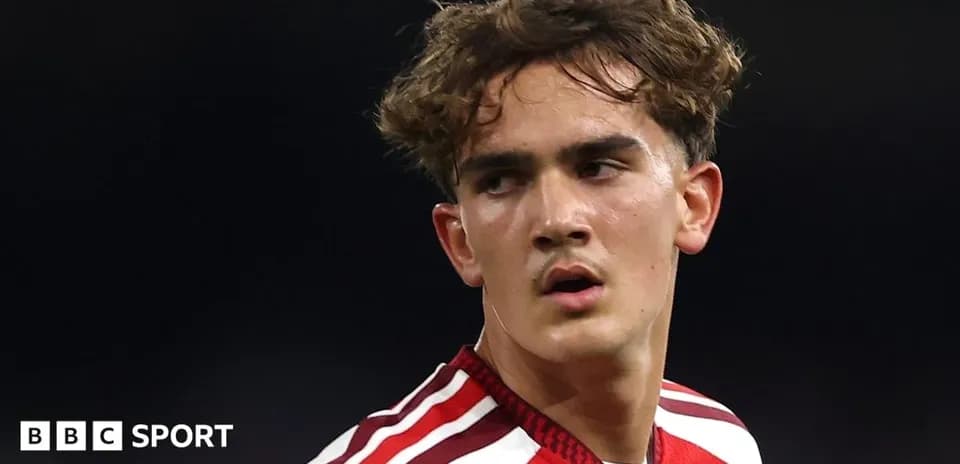 Football player in red jersey during match