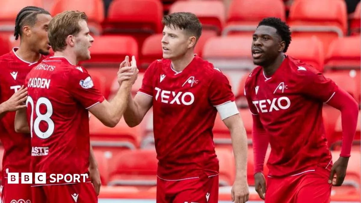 Players celebrating a goal during a match
