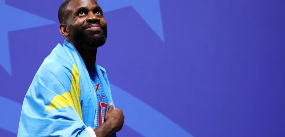 Athlete wearing a flag, looking upwards