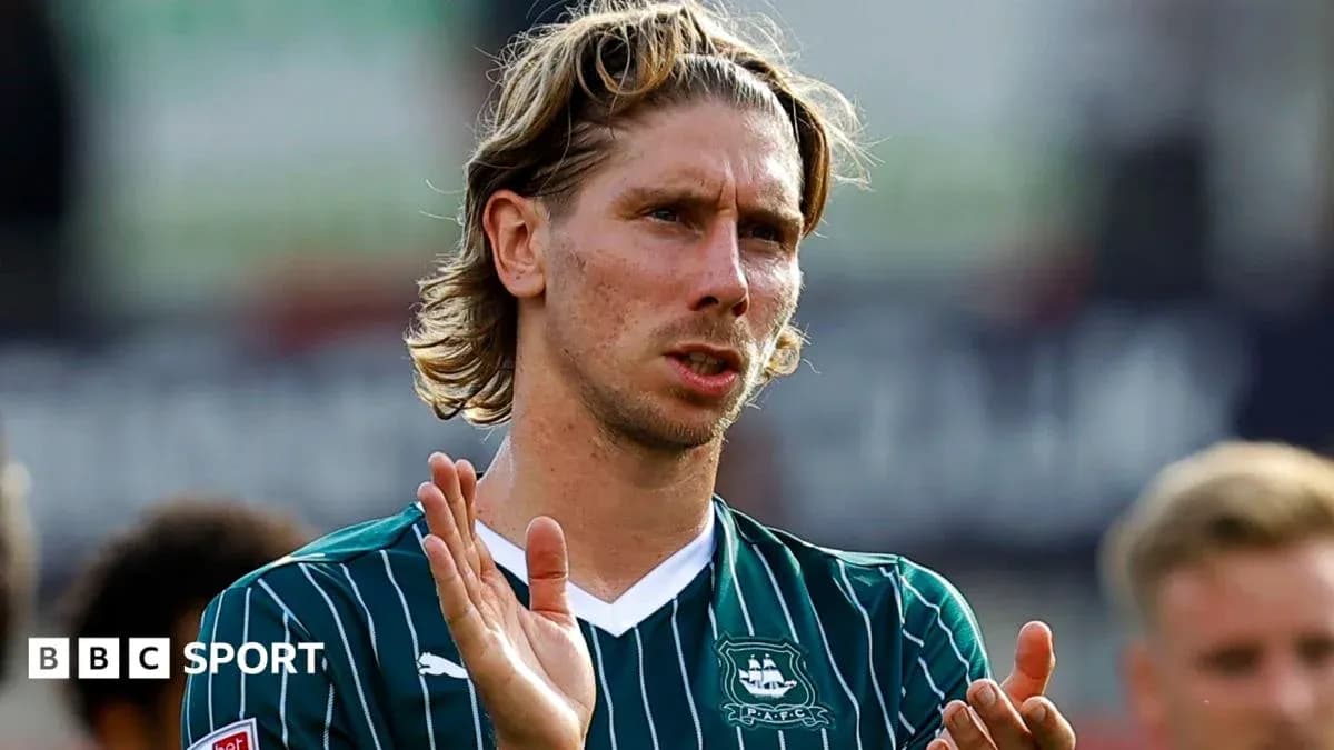 Player applauding fans in green team jersey