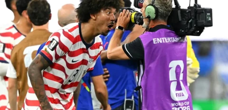 US player celebrating with camera after match