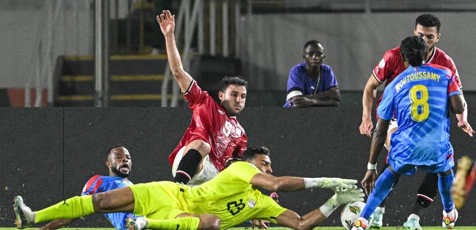 Players contesting for the ball near goal area