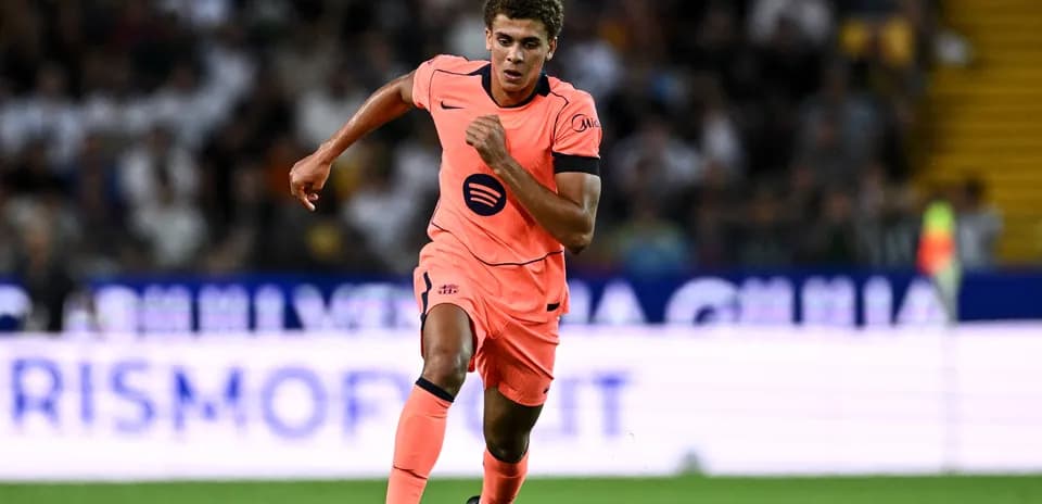 Player sprinting in bright pink kit during match