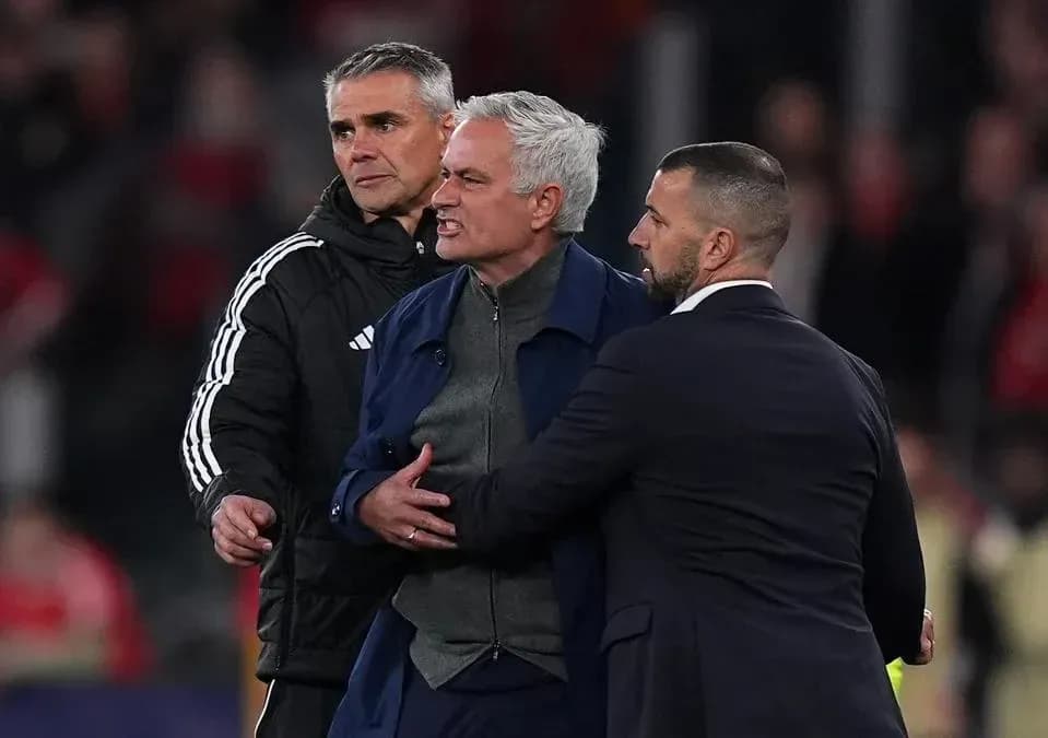 Jose Mourinho being restrained by staff during match