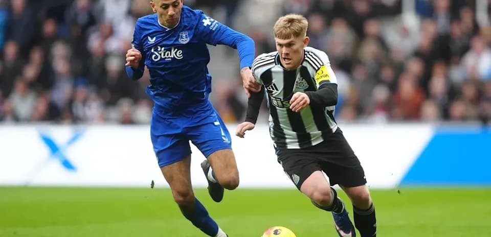 Two players competing for the ball on the field