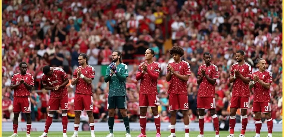Liverpool players lined up applauding at Anfield