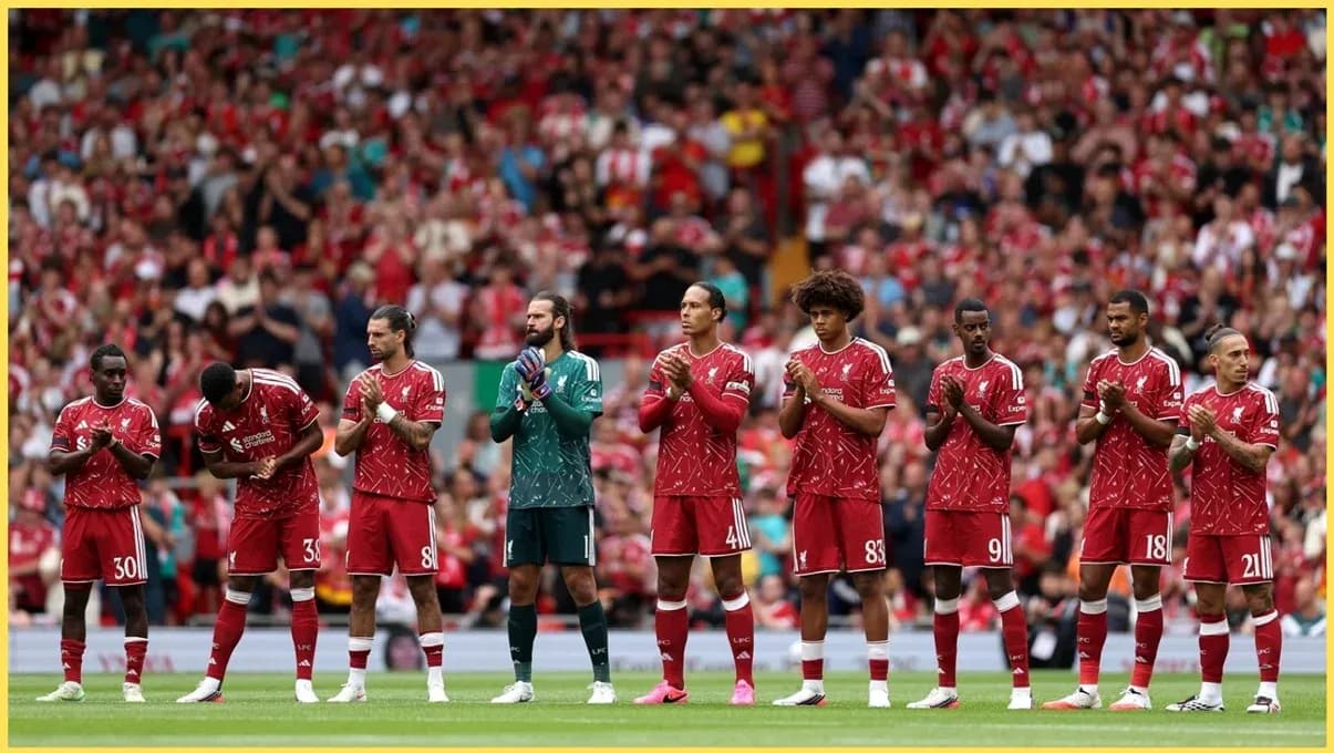 Liverpool players lined up applauding at Anfield