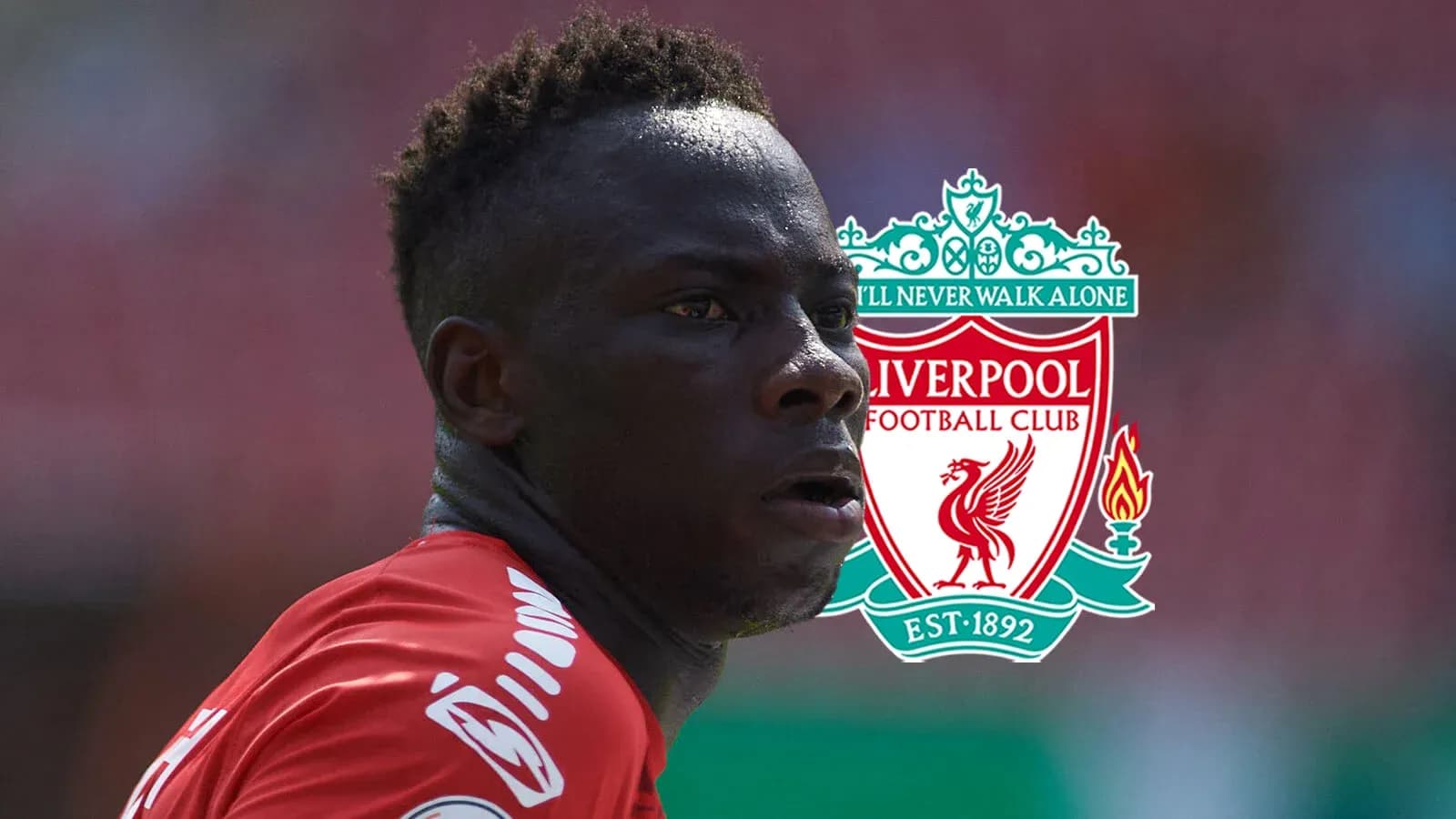 Player in Liverpool kit with club logo background
