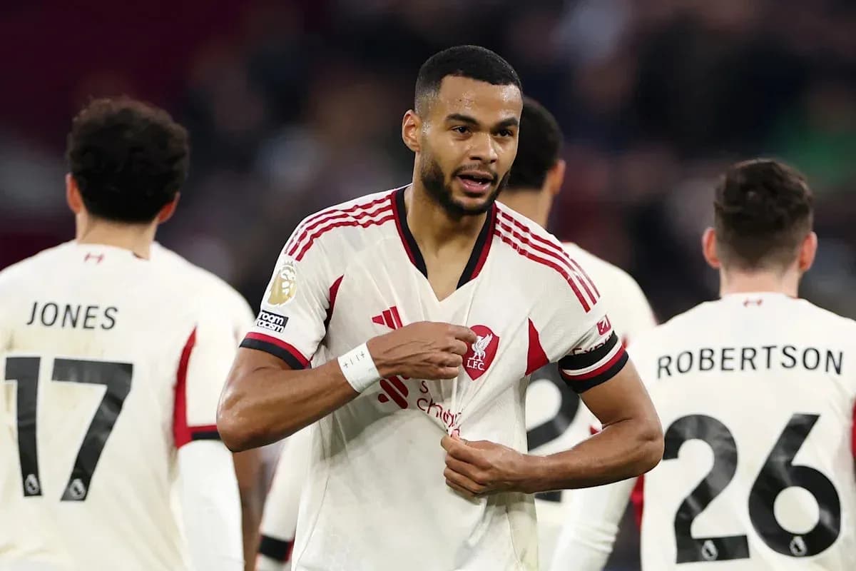 Liverpool player adjusting his jersey during match