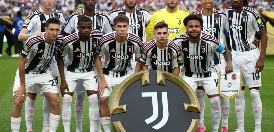Juventus team posing with club emblem before match
