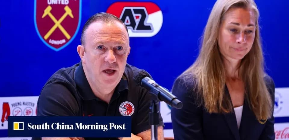 Man speaking at press conference with woman beside him