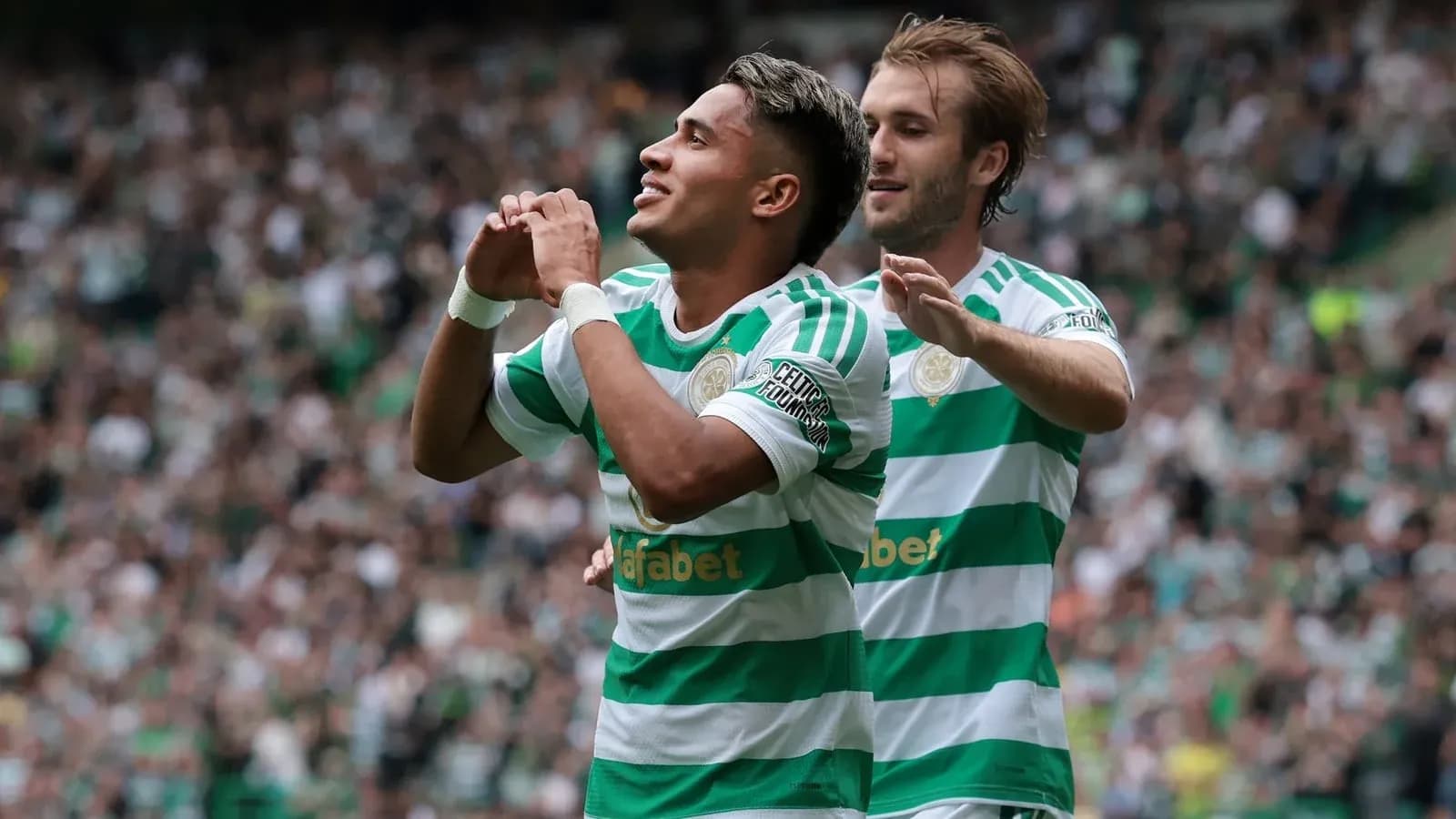 Celtic players celebrating a goal during a match