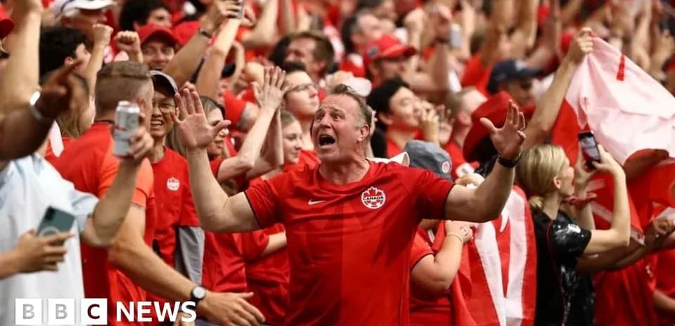 Fans celebrating in red during sporting event