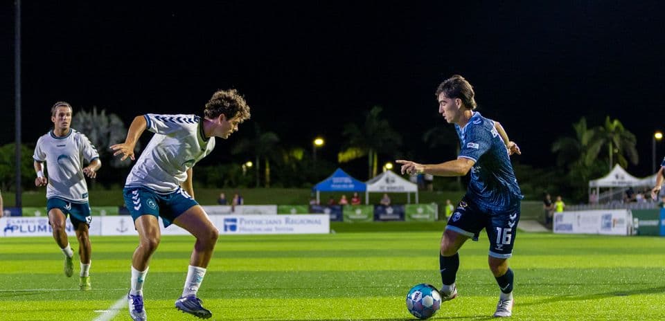 Players competing for the ball in USL match