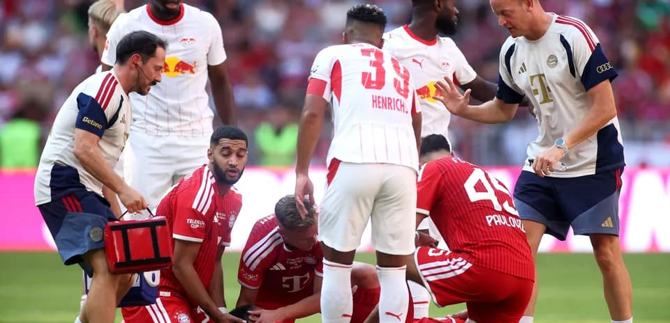 Players attending to an injured teammate on the field