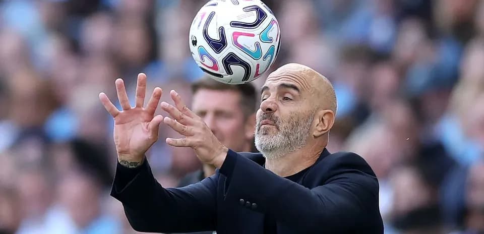 Coach attempting to catch a ball during match