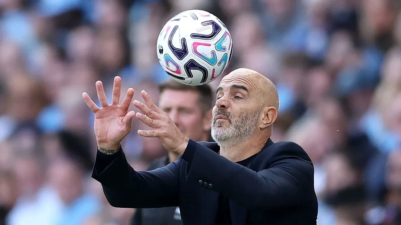 Coach attempting to catch a ball during match
