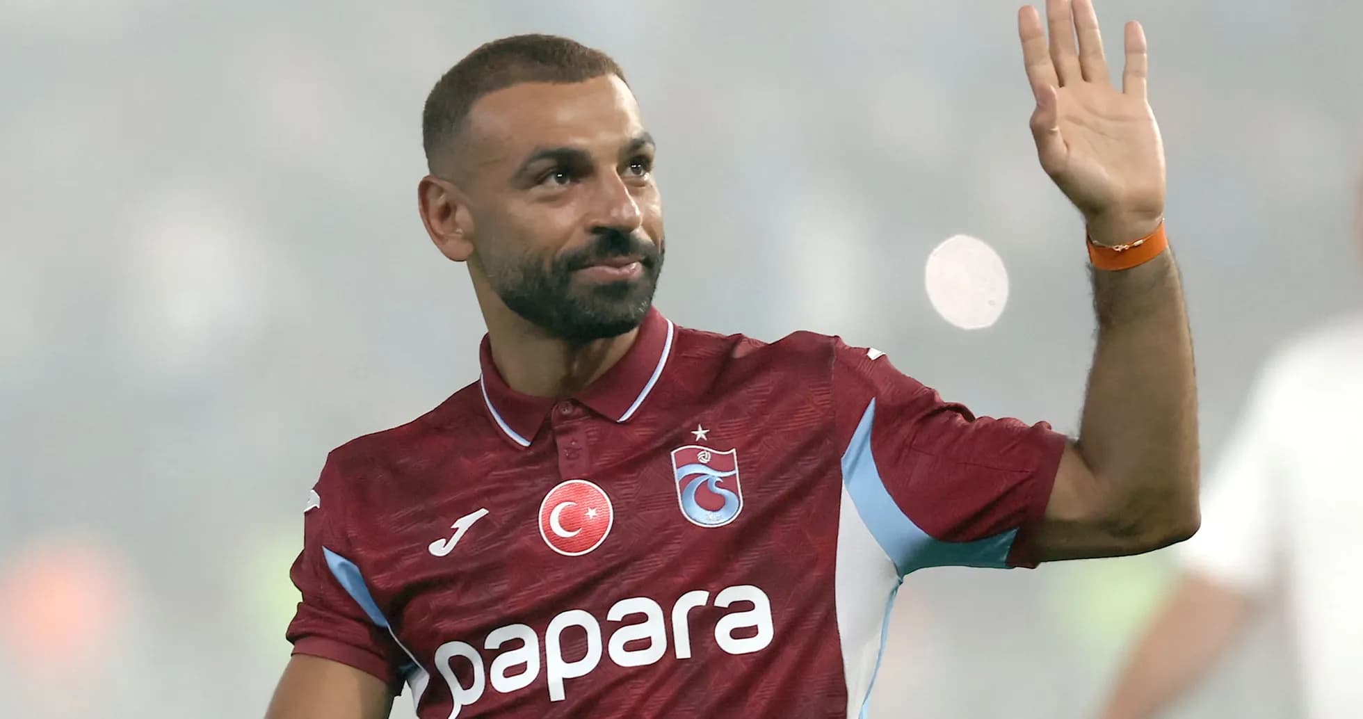 Player waving while wearing Trabzonspor jersey
