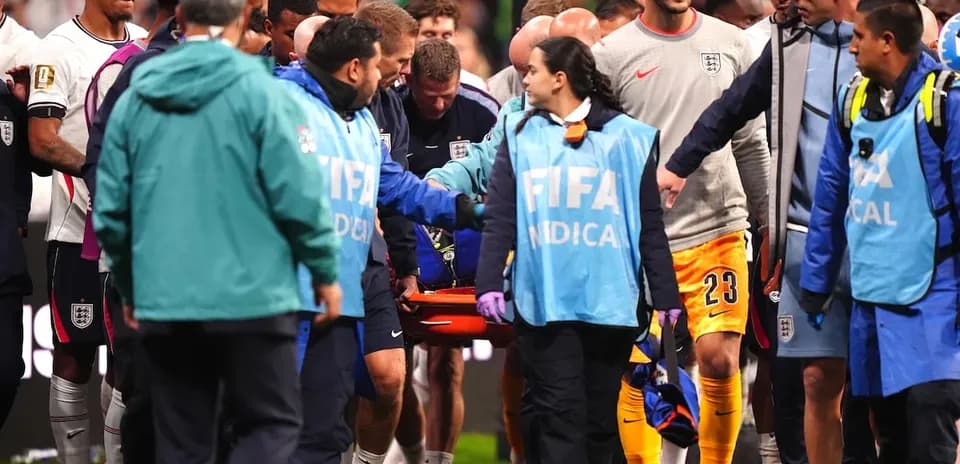 Medical team assisting player on stretcher during match