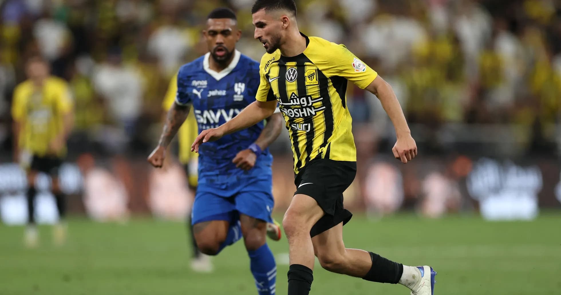 Player in yellow jersey dribbling the ball during match