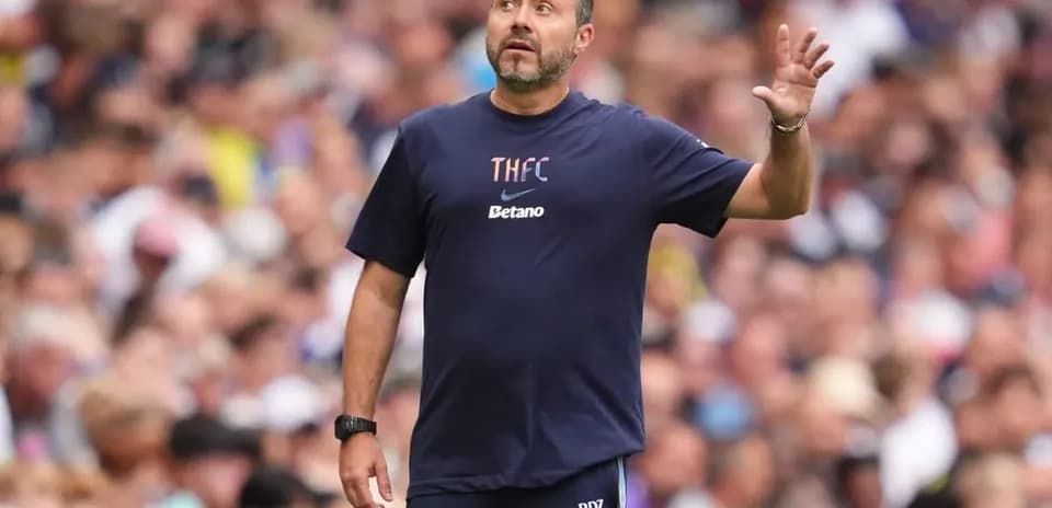 Coach gesturing during a match on the sidelines