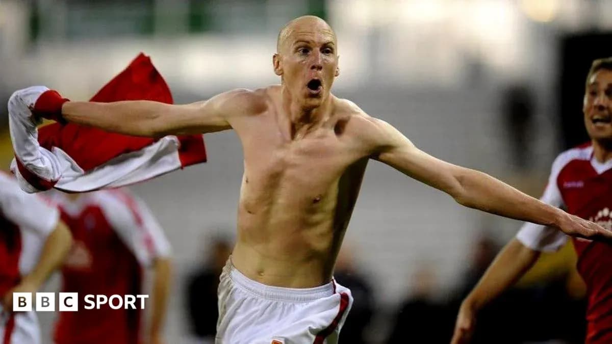 Player celebrating shirtless after scoring a goal