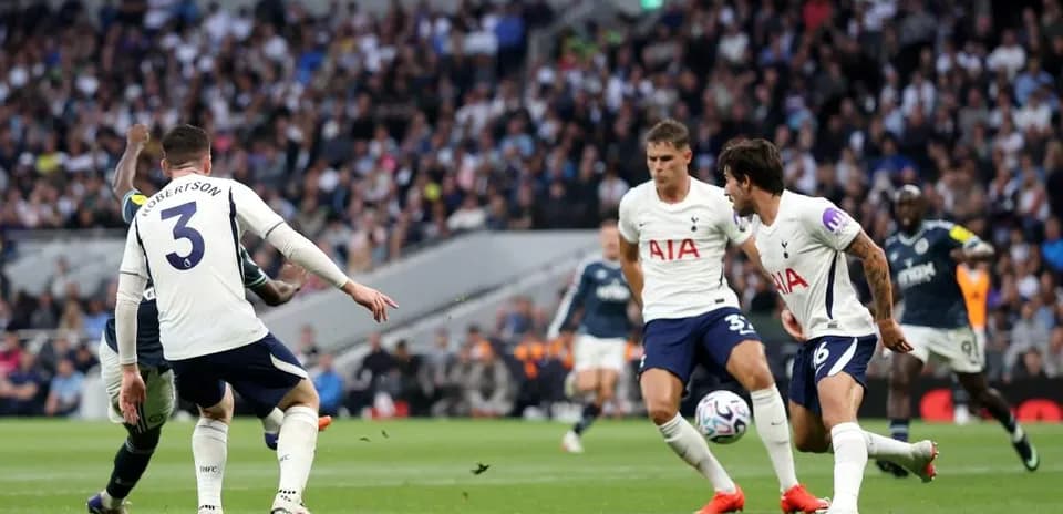 Tottenham players defending against opposing team in match