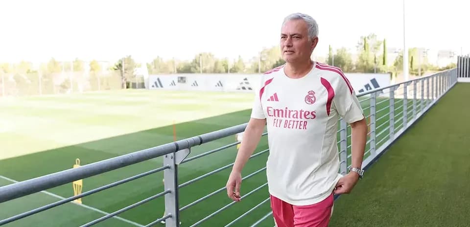Coach walking near training pitch at club facility