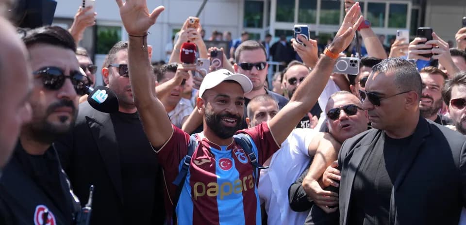 Player greeting fans surrounded by a crowd