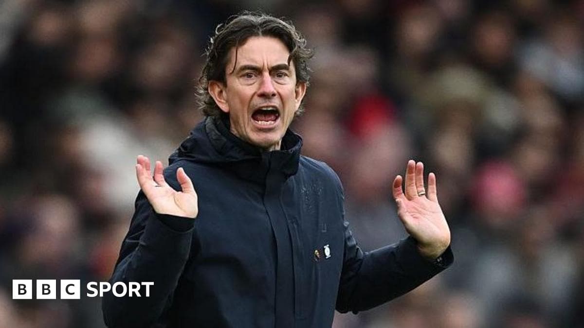 Manager gesturing during a match on the sideline