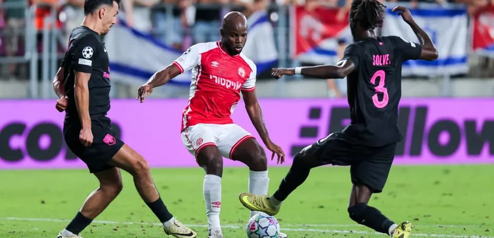Players competing for the ball in UEFA match