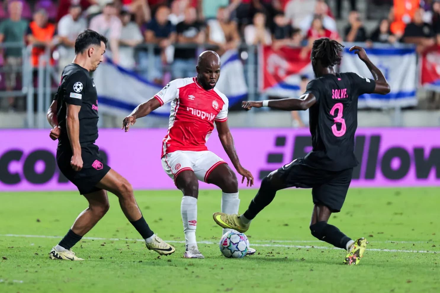 Players competing for the ball in UEFA match