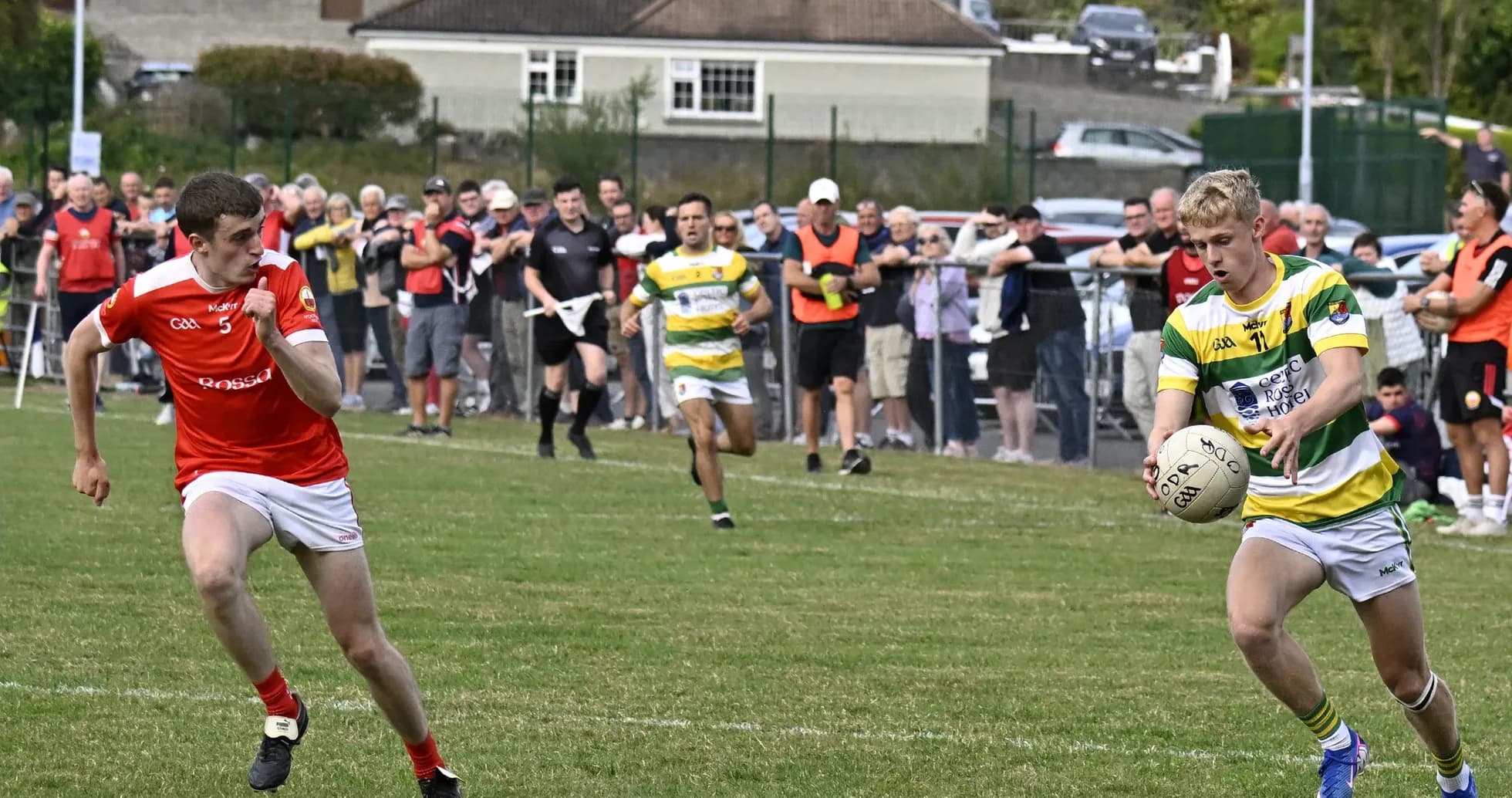 Player in green and yellow jersey receiving ball during match