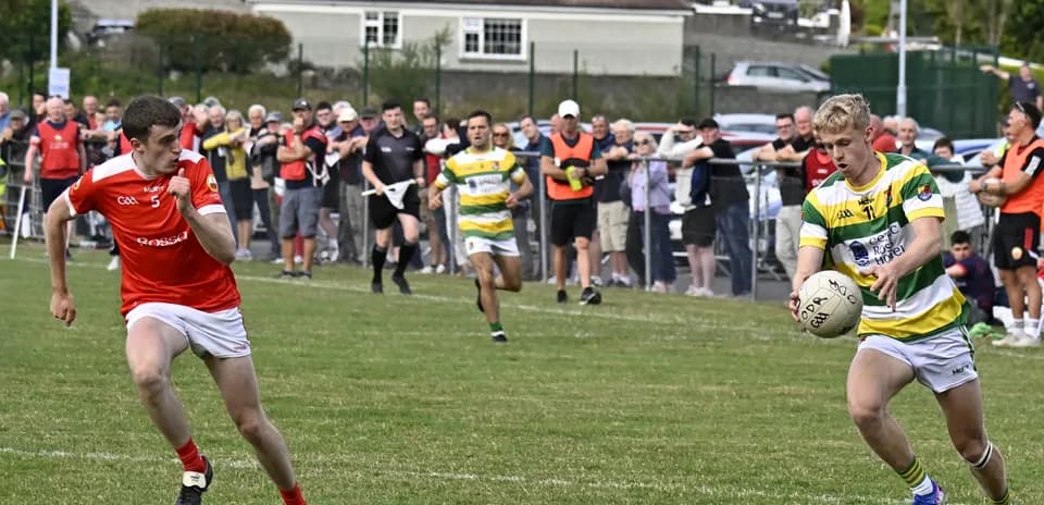 Player in green and yellow jersey receiving ball during match