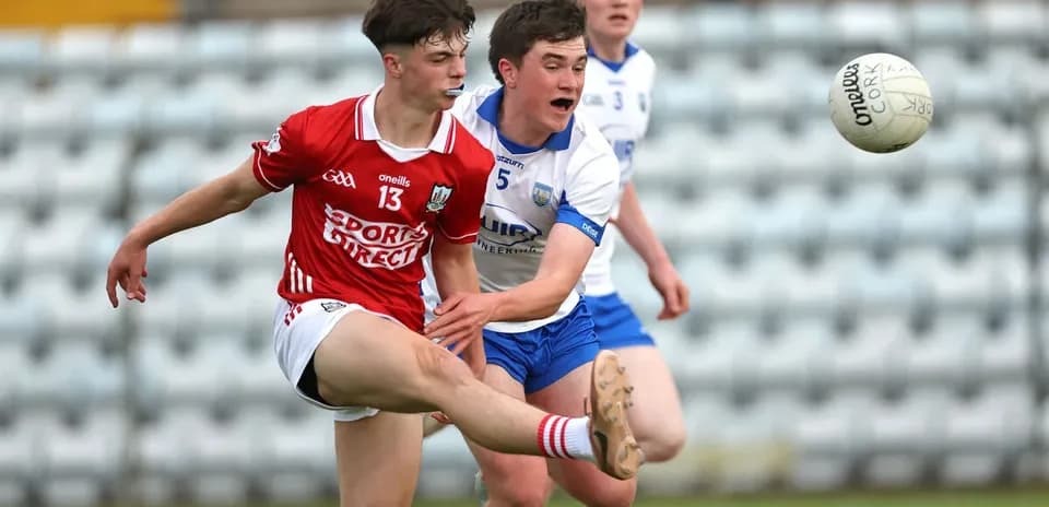 Player kicking the ball while being challenged by opponent