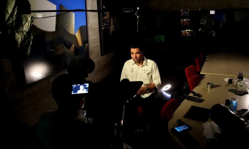 Person being interviewed in a studio setting