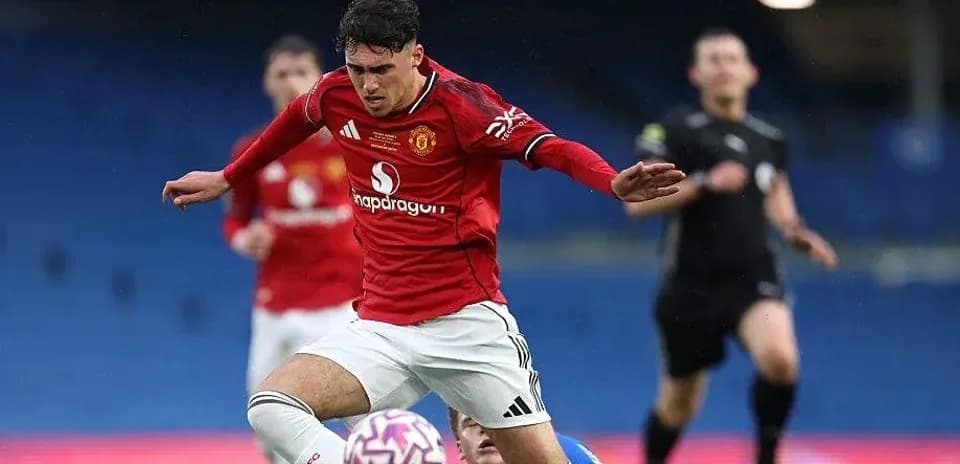 Player in red jersey falling during football match